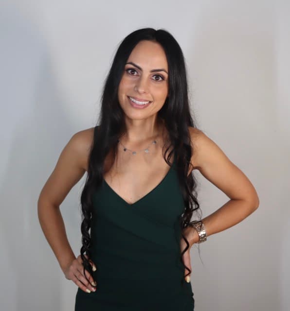 Original photo booth capture of a guest in a green dress against a plain backdrop